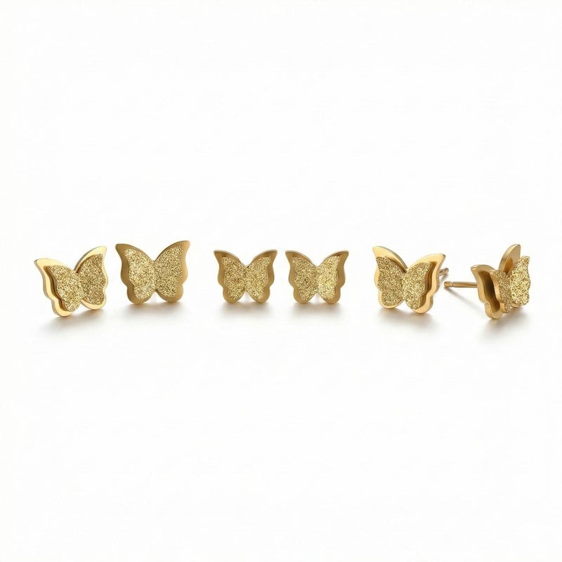 A set of 3 pairs of gold butterflies with a double design, made of rust-resistant stainless steel, with graduated sizes to give you layered styling or to choose the perfect size. - Image 1